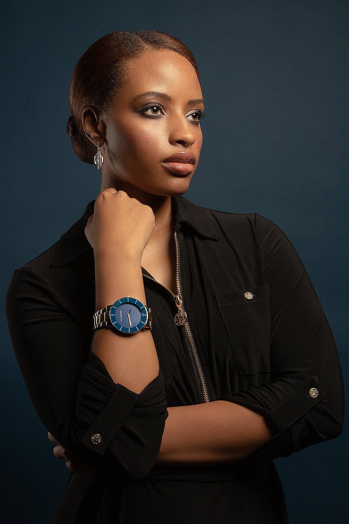 Jasmine in a tailored dark outfit with wristwatch