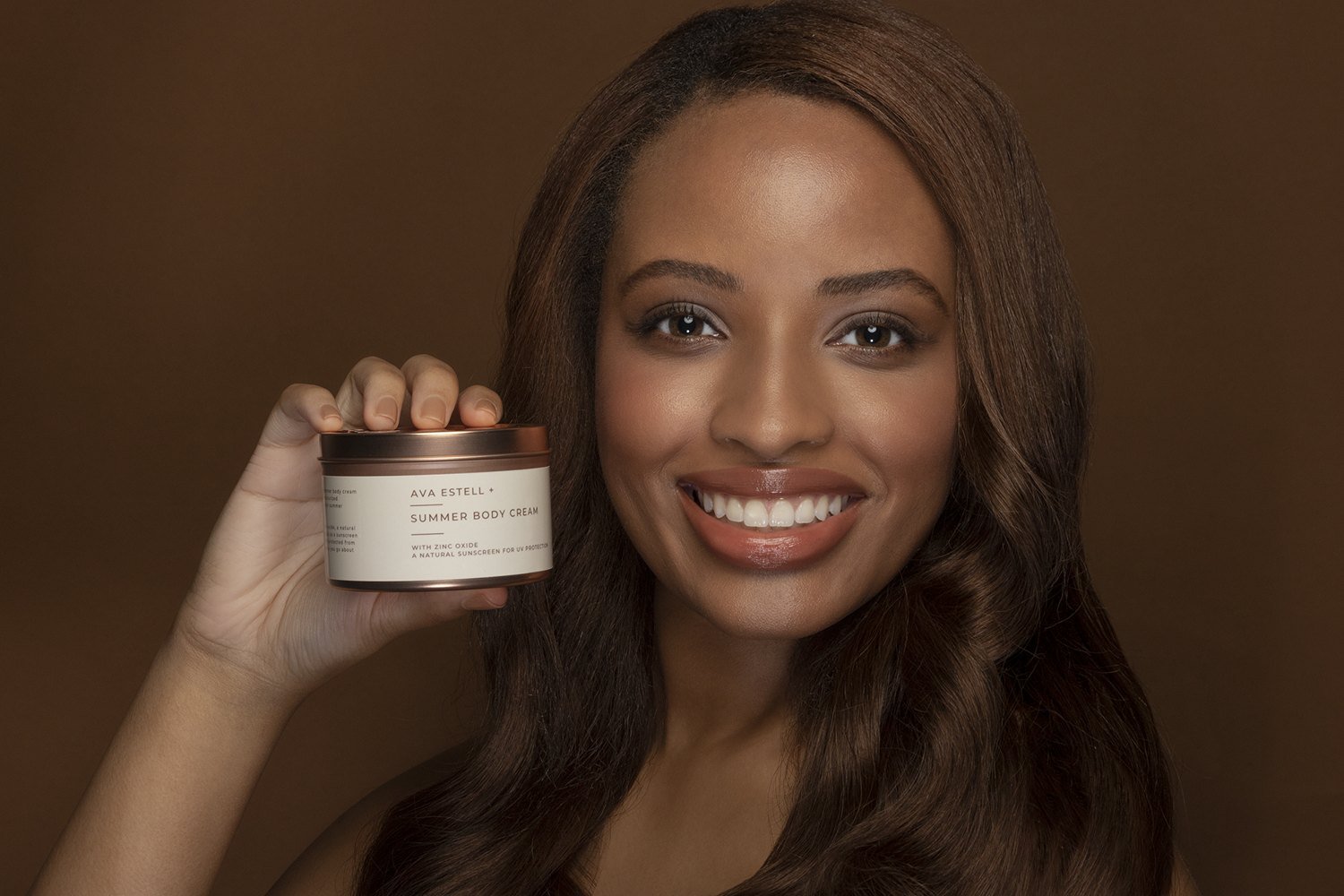 Jasmine holding a skincare product